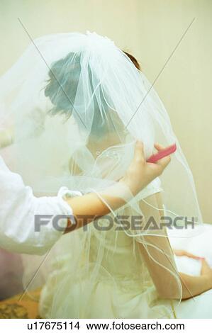 Picture - Hairstylist doing hair of bride. Fotosearch