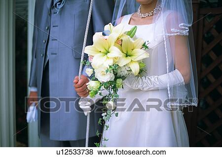 Stock Photo - Midsection of bride and groom. Fotosearch