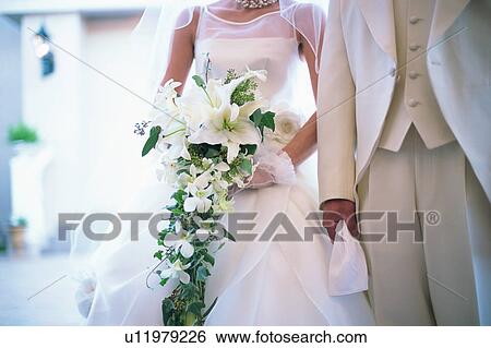 Midsection of bride and groom View Large Photo Image Stock Photograph - Midsection of bride and groom. Fotosearch