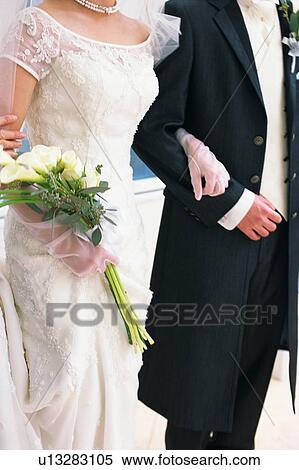 Stock Photography - Midsection of bride and groom. Fotosearch