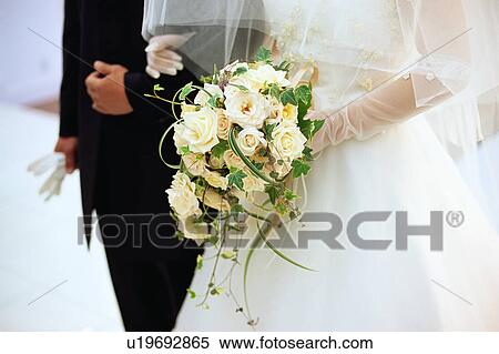 Stock Photography - Midsection of bride and groom. Fotosearch