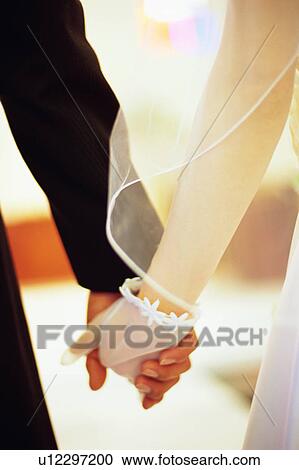 Stock Image - Rear view of bride and groom. Fotosearch
