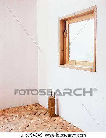 Stock Photo - A cylindrical container kept under window in a house. Fotosearch