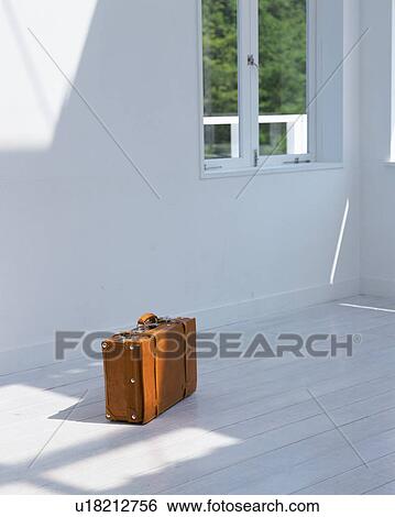 Stock Photograph - A leather suitcase on floor. Fotosearch