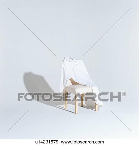 Stock Photo - A long white shirt on chair. Fotosearch