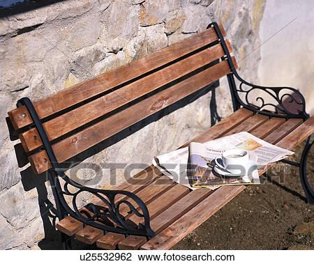 A newspaper and a cup of coffee on a wooden bench View Large Photo Image Stock Image - A newspaper and a cup of coffee on a wooden bench. Fotosearch