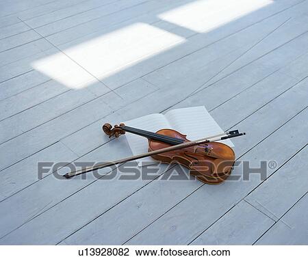 A violin and a bow on hardwood floor View Large Photo Image Stock Image - A violin and a bow on hardwood floor. Fotosearch