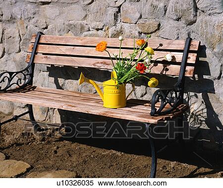 A watering can along with colorful flower on a wooden bench View Large Photo Image Stock Photography - A watering can along with colorful flower on a wooden bench. Fotosearch