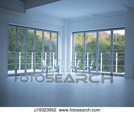 Four chairs placed against glass doors of a house View Large Photo Image Stock Image - Four chairs placed against glass doors of a house. Fotosearch