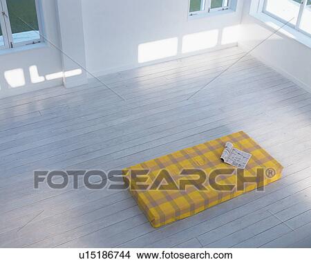 Picture - High angle view of a magazine kept on bed. Fotosearch
