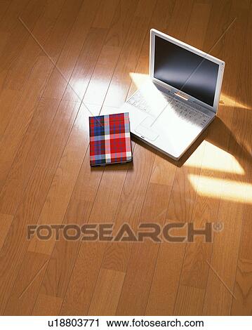 Notebook computer and a book on floor View Large Photo Image Stock Image - Notebook computer and a book on floor. Fotosearch