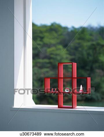 Red colored rack placed on windowsill View Large Photo Image Stock Photo - Red colored rack placed on windowsill. Fotosearch