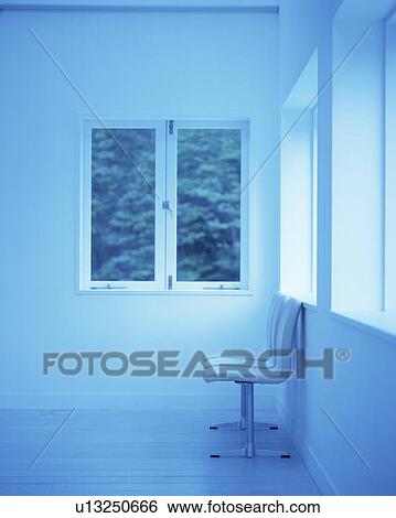 Stock Photograph - Side view of three chairs set against wall. Fotosearch