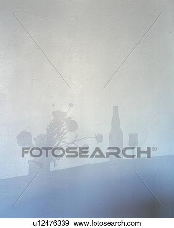 Stock Photo - Silhouette of a wineglass, bottle and a bunch of flowers. Fotosearch