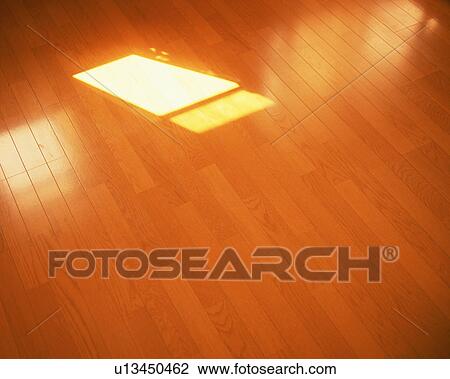 Stock Image - Sunlight reflected on hardwood floor. Fotosearch