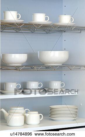 Stock Photograph - Dishes in a cupboard. Fotosearch