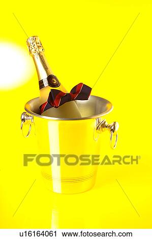 A bottle of champagne in a cooler View Large Photo Image Stock Image - A bottle of champagne in a cooler. Fotosearch
