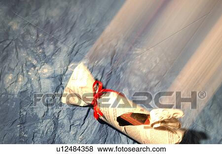Stock Photo - A bottle of wine wrapped by newspaper. Fotosearch