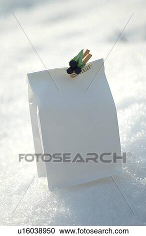 Stock Image - A single paper bag on snow. Fotosearch