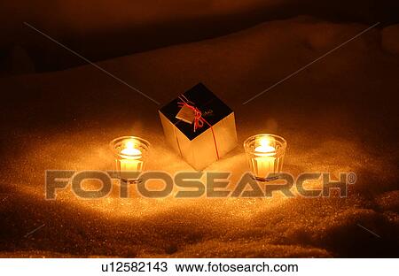 Gift box and illuminated candles View Large Photo Image Stock Image - Gift box and illuminated candles. Fotosearch