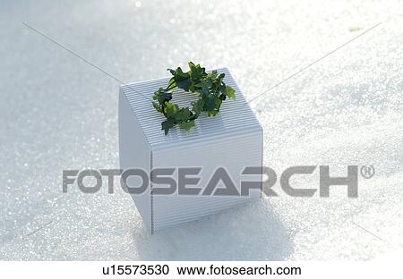 Stock Image - Gift box on snow. Fotosearch