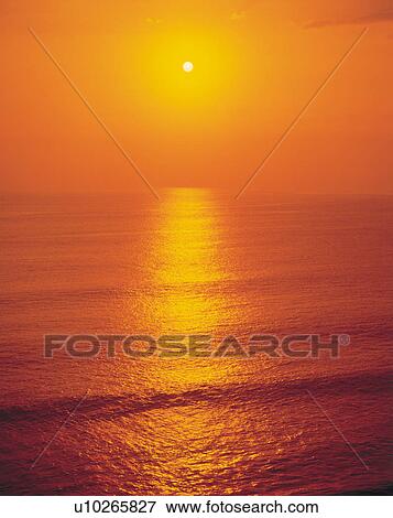 Stock Photo - Amazing seascape at sunset in Bali, Indonesia. Fotosearch