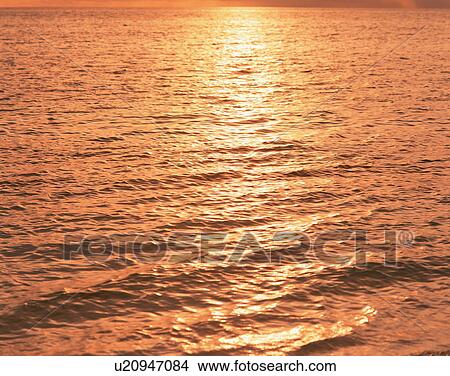 Picture - Sunlight reflected on surface of sea in Maldives. Fotosearch