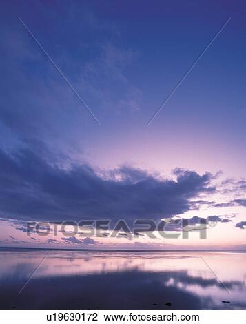 Stock Image - Sunset in Tahiti. Fotosearch