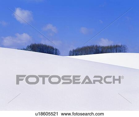 Stock Image - Snow mounds seen on a sunny day. Fotosearch