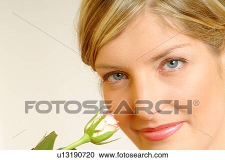 Stock Image - Portrait of Woman with single white rose. Fotosearch
