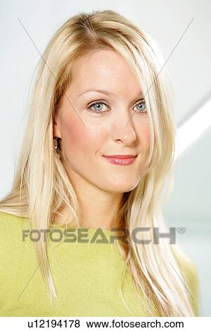Portrait of young business woman with long blond hair wearing green sweater View Large Photo Image Stock Photo - Portrait of young business woman with long blond hair wearing green sweater. Fotosearch