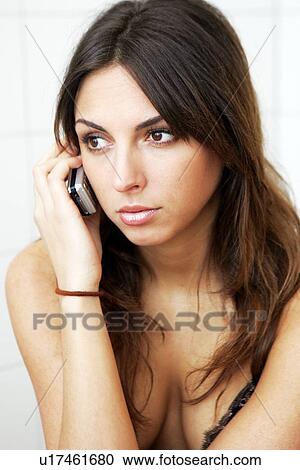 Portrait of young dark-haired woman using a cell phone View Large Photo Image Stock Image - Portrait of young dark-haired woman using a cell phone. Fotosearch