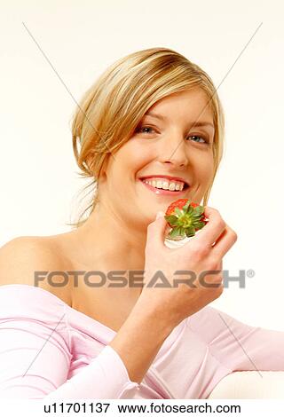 Woman eating strawberry View Large Photo Image Stock Photo - Woman eating strawberry. Fotosearch