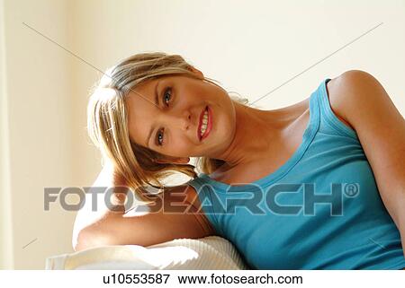 Stock Photo - Woman relaxing on sofa. Fotosearch