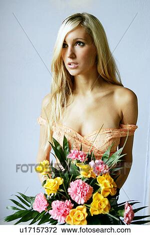Young woman in see-through top holding bouquet of flowers View Large Photo Image Stock Image - Young woman in see-through top holding bouquet of flowers. Fotosearch