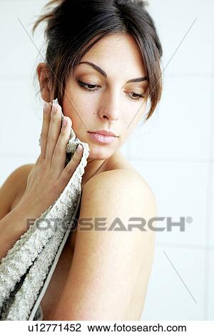 Young woman getting out of bathtub, rubbing herself dry with towel View Large Photo Image Stock Image - Young woman getting out of bathtub, rubbing herself dry with towel. Fotosearch