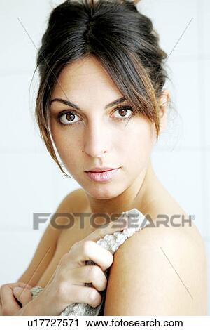 Young woman getting out of bathtub, rubbing herself dry with towel View Large Photo Image Stock Image - Young woman getting out of bathtub, rubbing herself dry with towel. Fotosearch