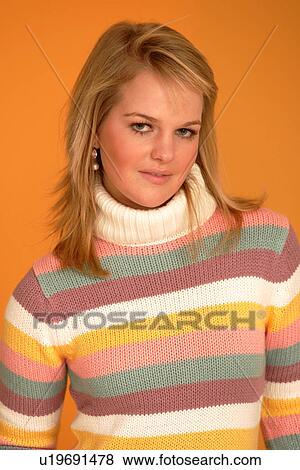 Portrait of young woman wearing striped turtleneck jumper, smiling View Large Photo Image Stock Photo - Portrait of young woman wearing striped turtleneck jumper, smiling. Fotosearch