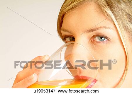 Close-up of Woman drinking juice View Large Photo Image Stock Photo - Close-up of Woman drinking juice. Fotosearch