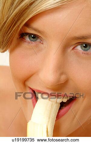 Stock Photography - Close-up of Woman eating banana. Fotosearch