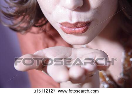 Face detail: woman's mouth blowing a kiss, close up View Large Photo Image Stock Photo - Face detail: woman's mouth blowing a kiss, close up. Fotosearch
