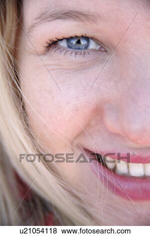 Portrait of young blond woman smiling, close up View Large Photo Image Stock Photo - Portrait of young blond woman smiling, close up. Fotosearch