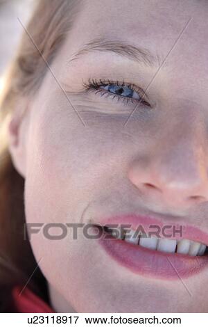 Stock Photo - Portrait of young blond woman smiling, close up. Fotosearch