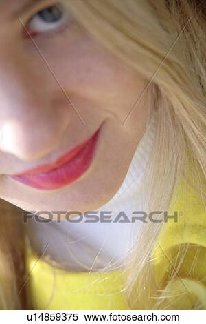 Stock Photography - Portrait of young blond woman smiling, close up. Fotosearch