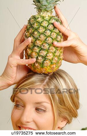 Woman with pineapple on her head View Large Photo Image Stock Photography - Woman with pineapple on her head. Fotosearch