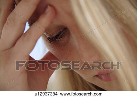 Young blond woman resting head on her hand, having headaches, close up View Large Photo Image Picture - Young blond woman resting head on her hand, having headaches, close up. Fotosearch