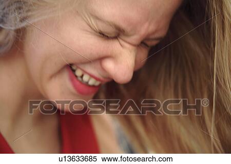 Young woman smiling with closed eyes, squinting, close up View Large Photo Image Stock Photography - Young woman smiling with closed eyes, squinting, close up. Fotosearch