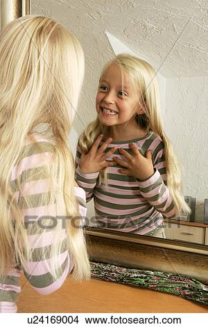 Girl grimacing in front of mirror View Large Photo Image Picture - Girl grimacing in front of mirror. Fotosearch