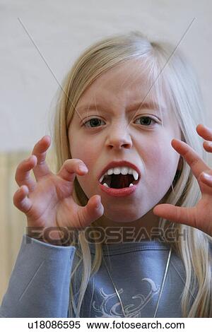 Portrait of blond girl with fake vampire's teeth View Large Photo Image Stock Photography - Portrait of blond girl with fake vampire's teeth. Fotosearch