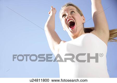 Young blond woman dancing, jumping and cheering at the beach, worm's eye view View Large Photo Image Stock Image - Young blond woman dancing, jumping and cheering at the beach, worm's eye view. Fotosearch